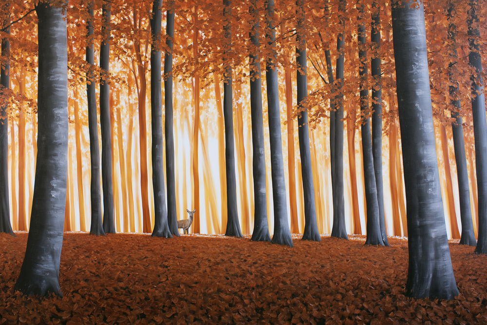 Deer among the tall trunks of an autumn beech wood
