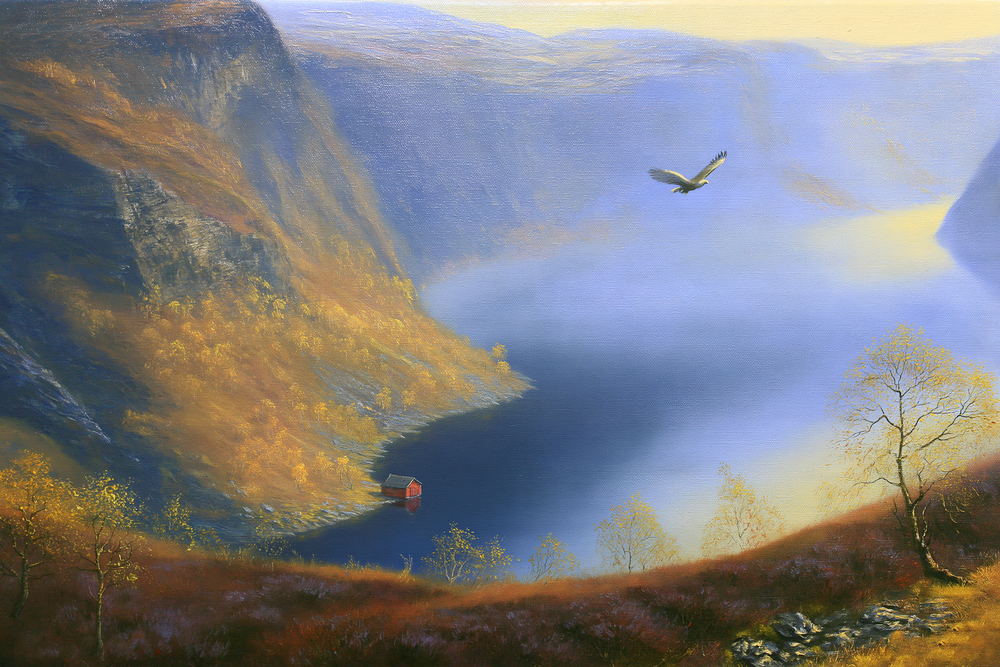 Steep golden slopes falling away to a deep blue fjord
